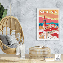 Sardinia Poster Print displayed in a cozy indoor setting with a hanging chair and stylish decor.