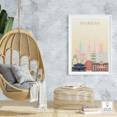 Stylish Shanghai skyline print on wall above cozy chair and ottoman, featuring warm pastel tones and iconic architecture.