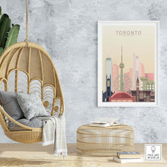 Toronto skyline print in warm pastel tones displayed in a stylish living space with hanging chair and decorative elements.