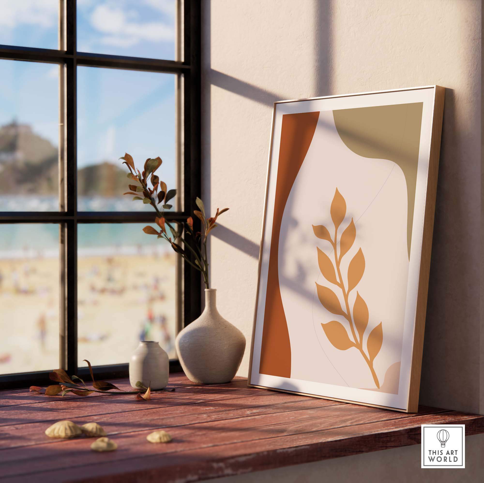 Framed leaf wall art displayed on a windowsill, adding a modern touch to home decor with a beach view.