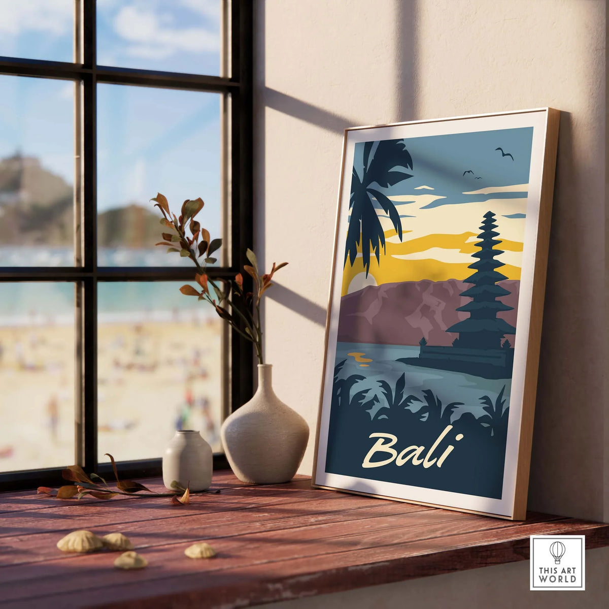 Bali Poster Wall Art Print displayed by a window, featuring tropical scenery and a temple with sunset colors.