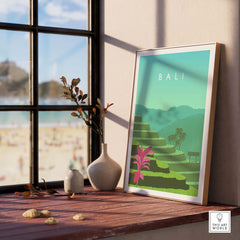 Bali Print Wall Art Poster displayed on a wooden table, featuring tropical landscapes and vibrant colors.