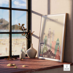Bangkok Skyline Poster Print displayed indoors with beach view, featuring pastel city architecture in a stylish frame.
