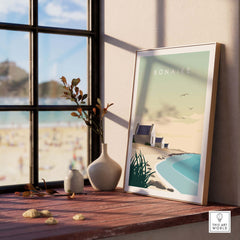 Bonaire travel poster print displayed on a windowsill, featuring minimalist design and beach view.
