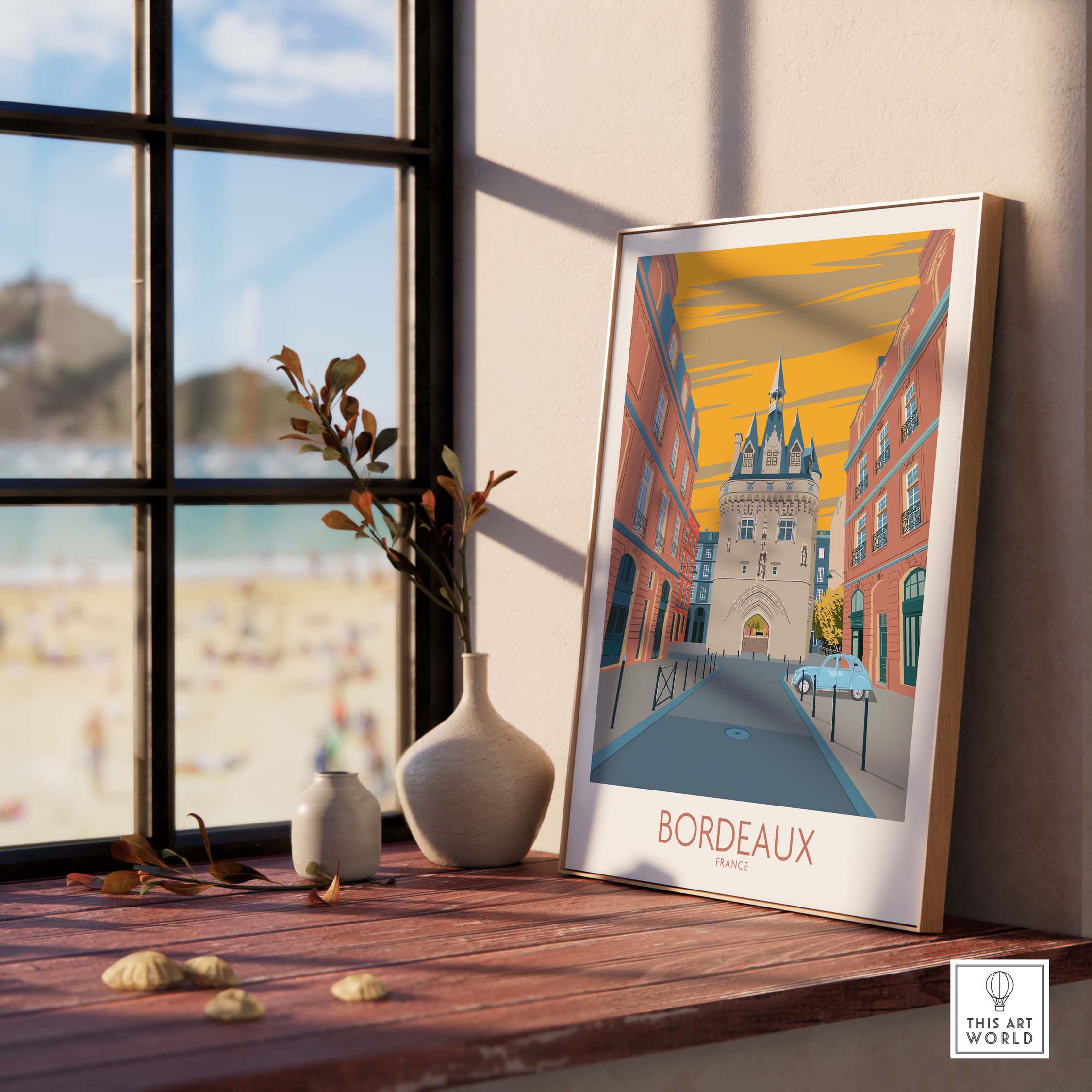 Framed Bordeaux travel poster on a wooden table with a beach view, adding a stylish touch to home decor.