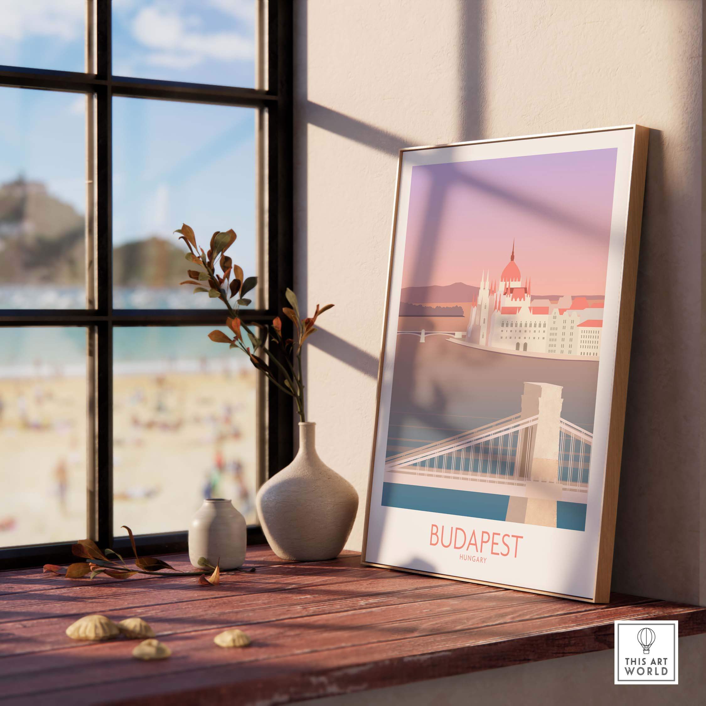 Budapest Print featuring Chain Bridge, framed art on a wood table, showcasing vintage travel inspiration.