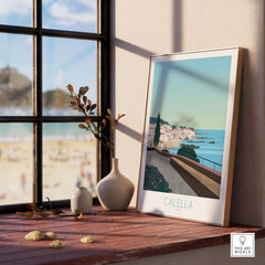 Costa Brava Calella Spain poster framed by a window, showcasing scenic coastal view and beach vibes.