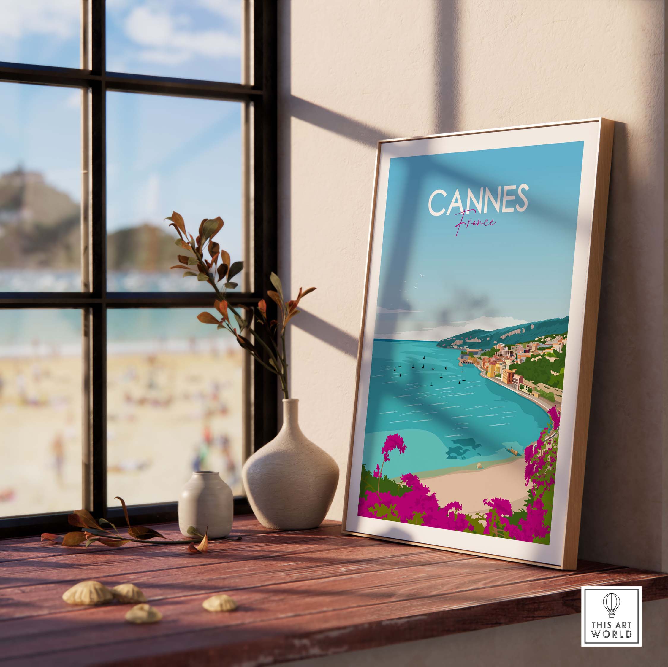 Framed Cannes Poster France Print displayed by a window, showcasing a coastal landscape in a minimalist style.