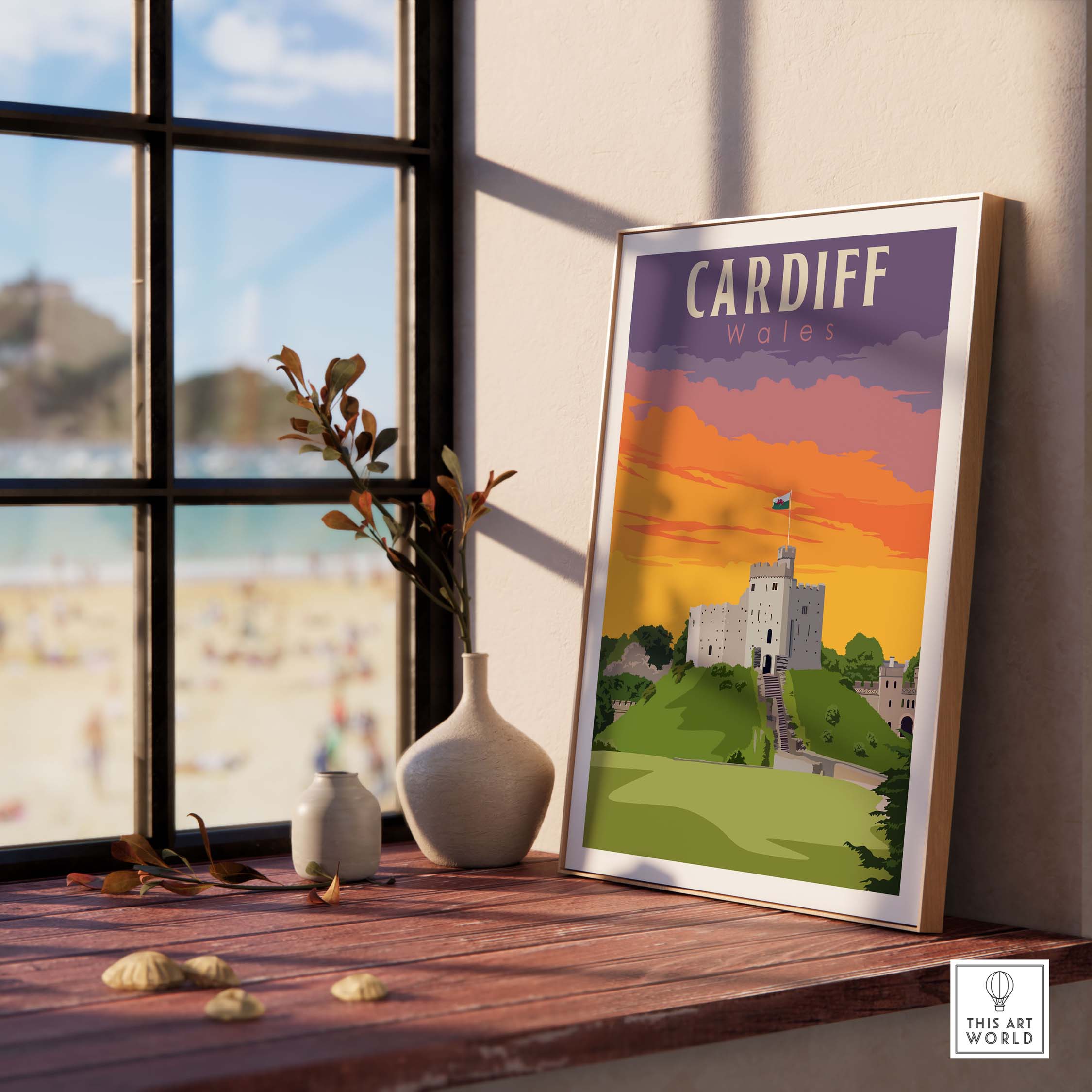Cardiff Poster Wales Print displayed near a window with beach view, featuring vibrant colors and nostalgic design.