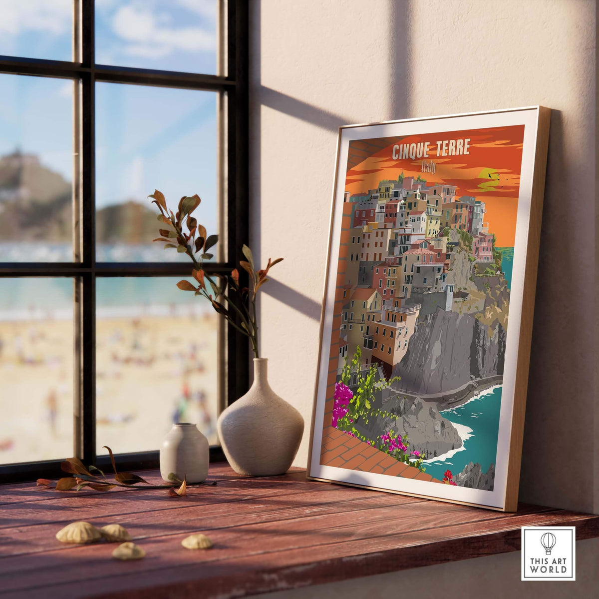 Cinque Terre Italy vintage poster print artwork displayed in a light-filled room by the beach.