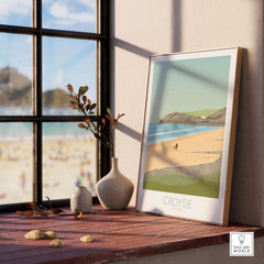 Croyde Beach Print poster displayed on a window sill, showcasing Devon's scenic coastline in a stylish interior setting.