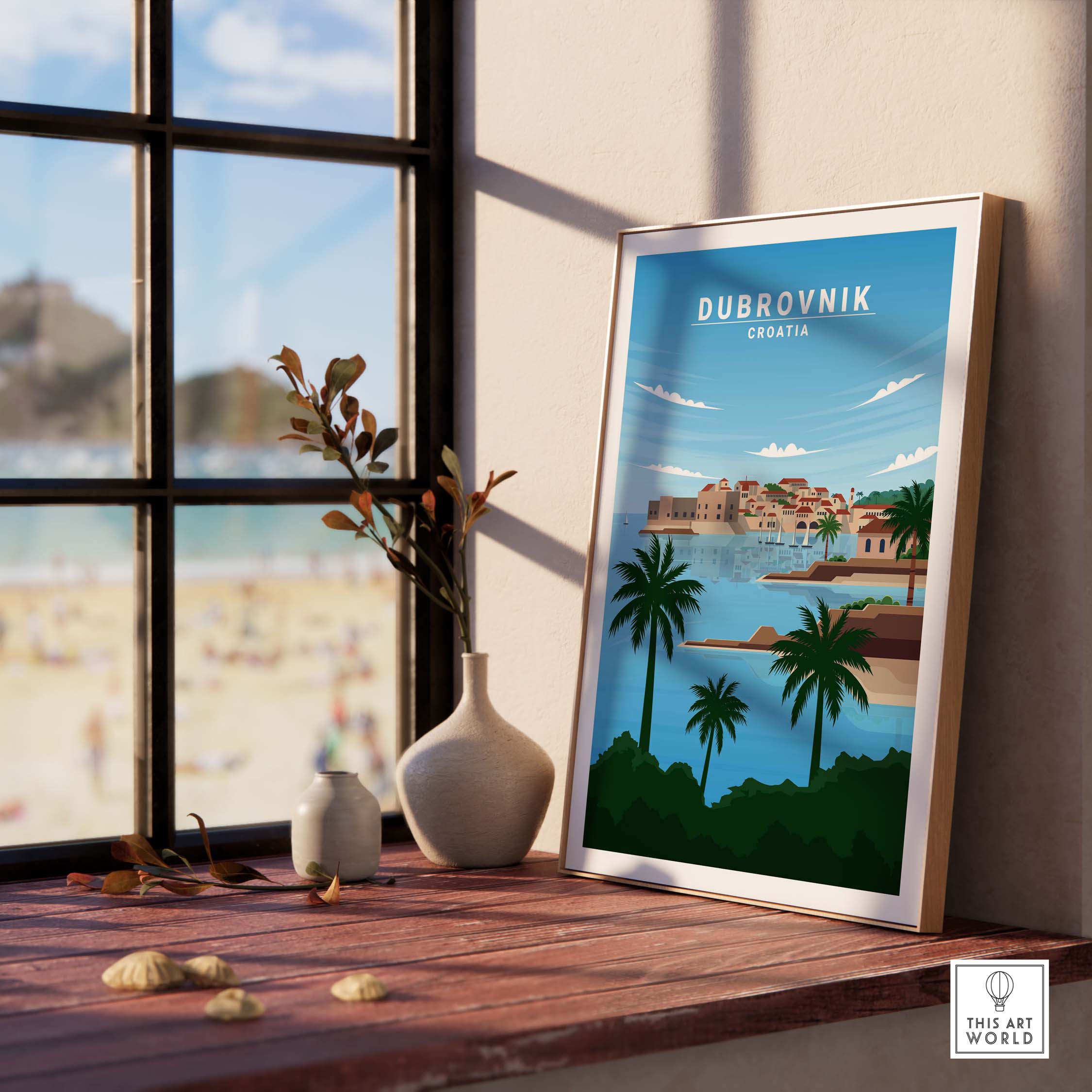 Dubrovnik art print in a stylish frame on a windowsill, showcasing a beautiful beach view in Croatia.