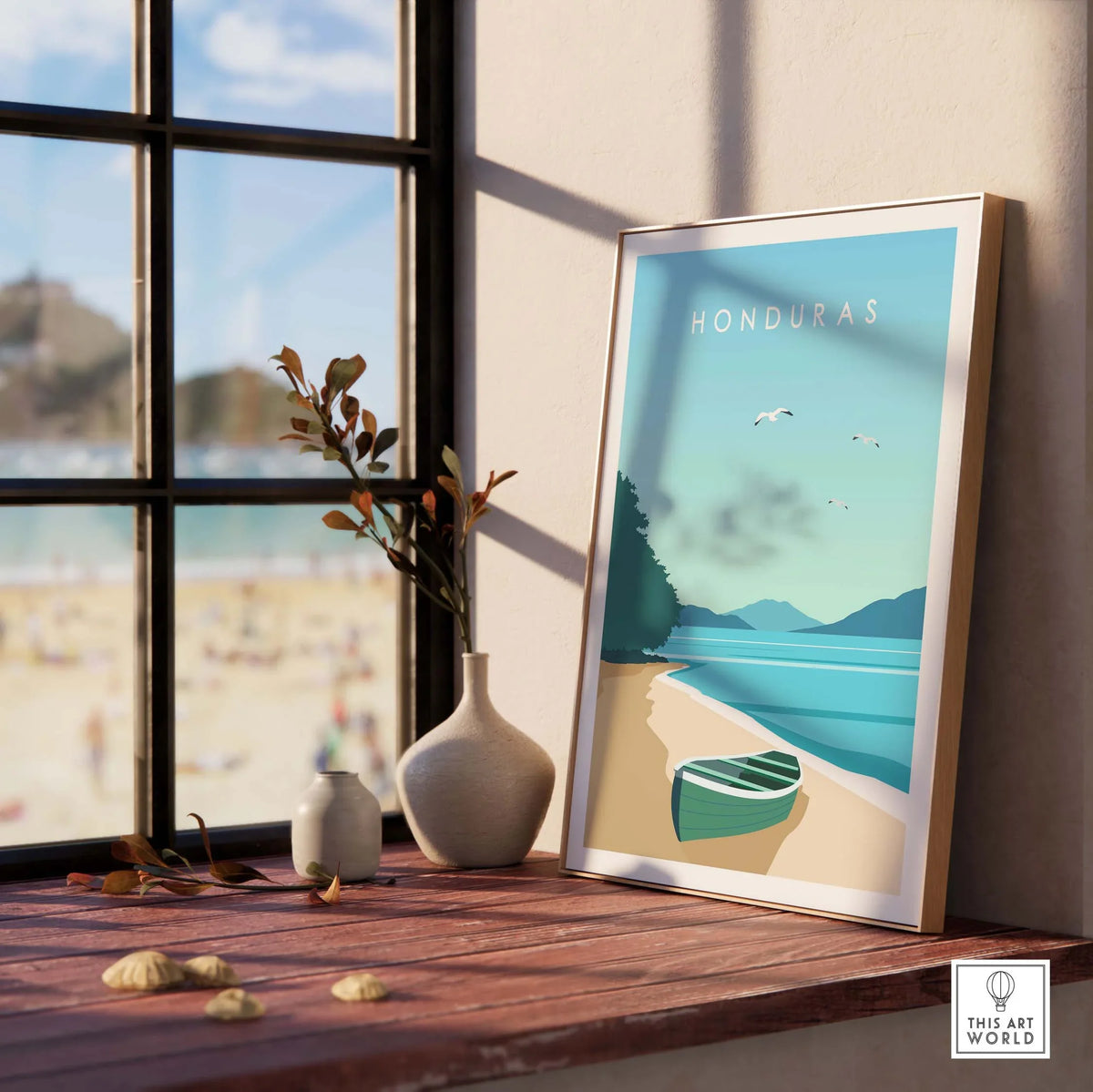 Honduras travel print displaying a beach scene with a boat, framed and styled in a sunlit room.