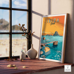 Ibiza Print Spain Sunset Poster framed on a wooden table with beach view, capturing vintage travel art inspiration.