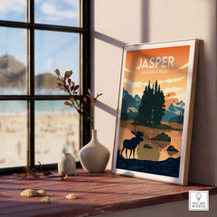 Jasper National Park poster featuring vibrant nature scene with a moose, framed art on a wooden table.