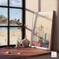 Kuala Lumpur skyline wall art print displayed on a windowsill with a beach view, showcasing iconic architecture in pastel tones.