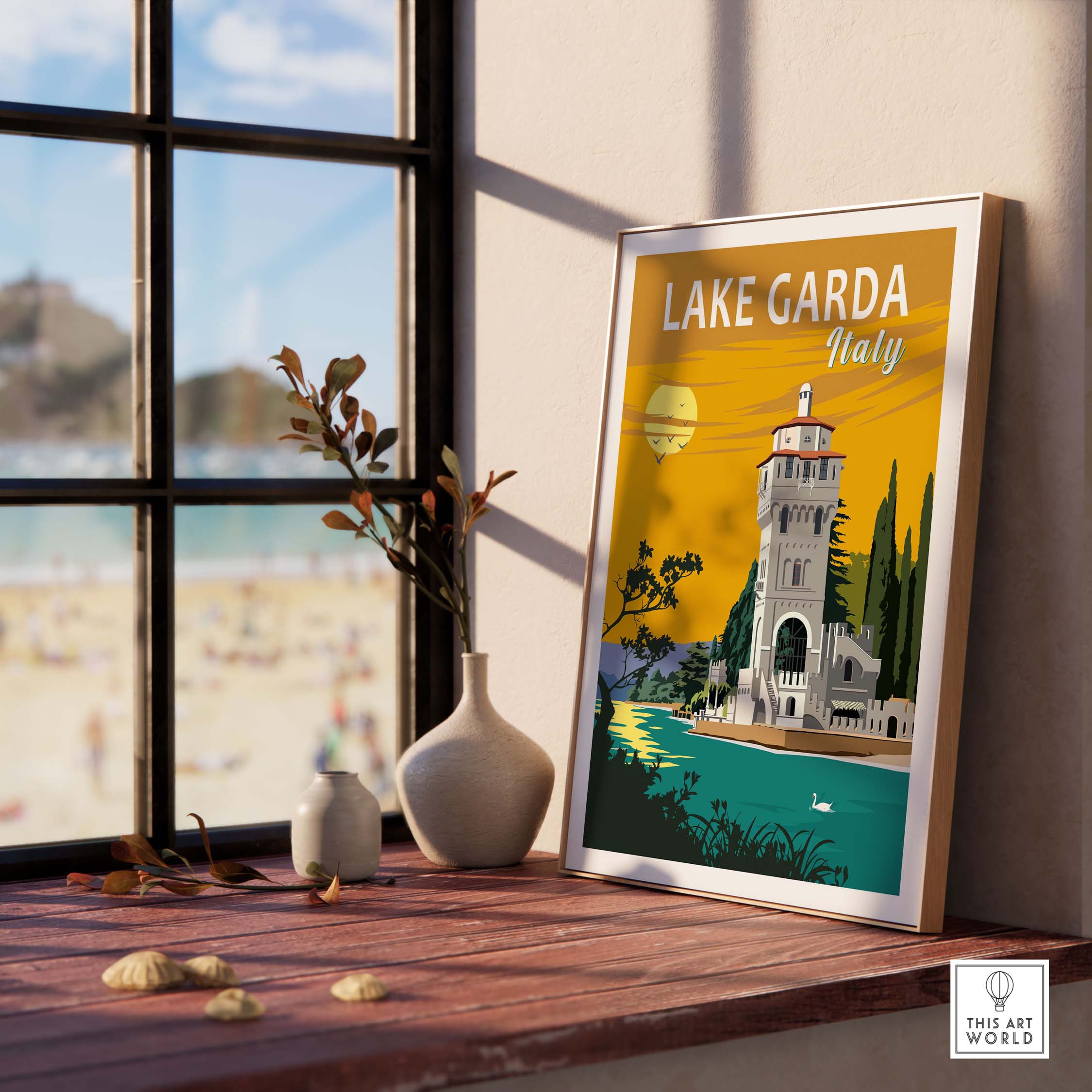 Lake Garda Print Italy poster displayed on a windowsill with a beach view, ideal for home or office decor.