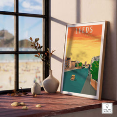 Leeds Poster Print displayed on a wooden table near a window, showcasing vintage travel art inspired by England.
