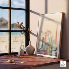 London skyline print wall art in pastel colors displayed on a wooden table by a window.