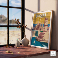 Framed Marseille Print showcasing vintage travel art, displayed in a stylish interior with a beach view.