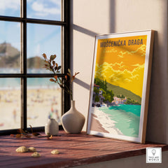 Mošćenička Draga Croatia poster print displayed indoors near a beach view, showcasing vibrant travel art.