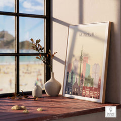 Munich skyline print displayed on a wooden table by a window, featuring pastel-colored city architecture.