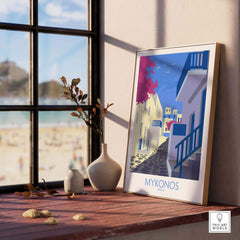 Stylish Mykonos print travel poster displayed on a wooden table with a coastal view, enhancing home decor.
