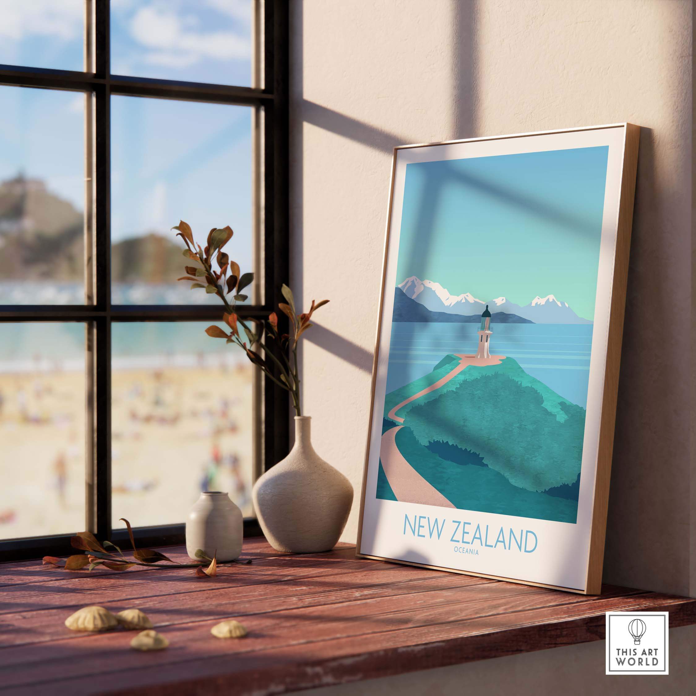 New Zealand Print Travel Poster displayed on a wooden table with a vase, showcasing a scenic coastline and lighthouse.