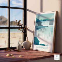 Framed Niagara Falls print wall art displayed on a windowsill with a beach view, bringing travel nostalgia and style.