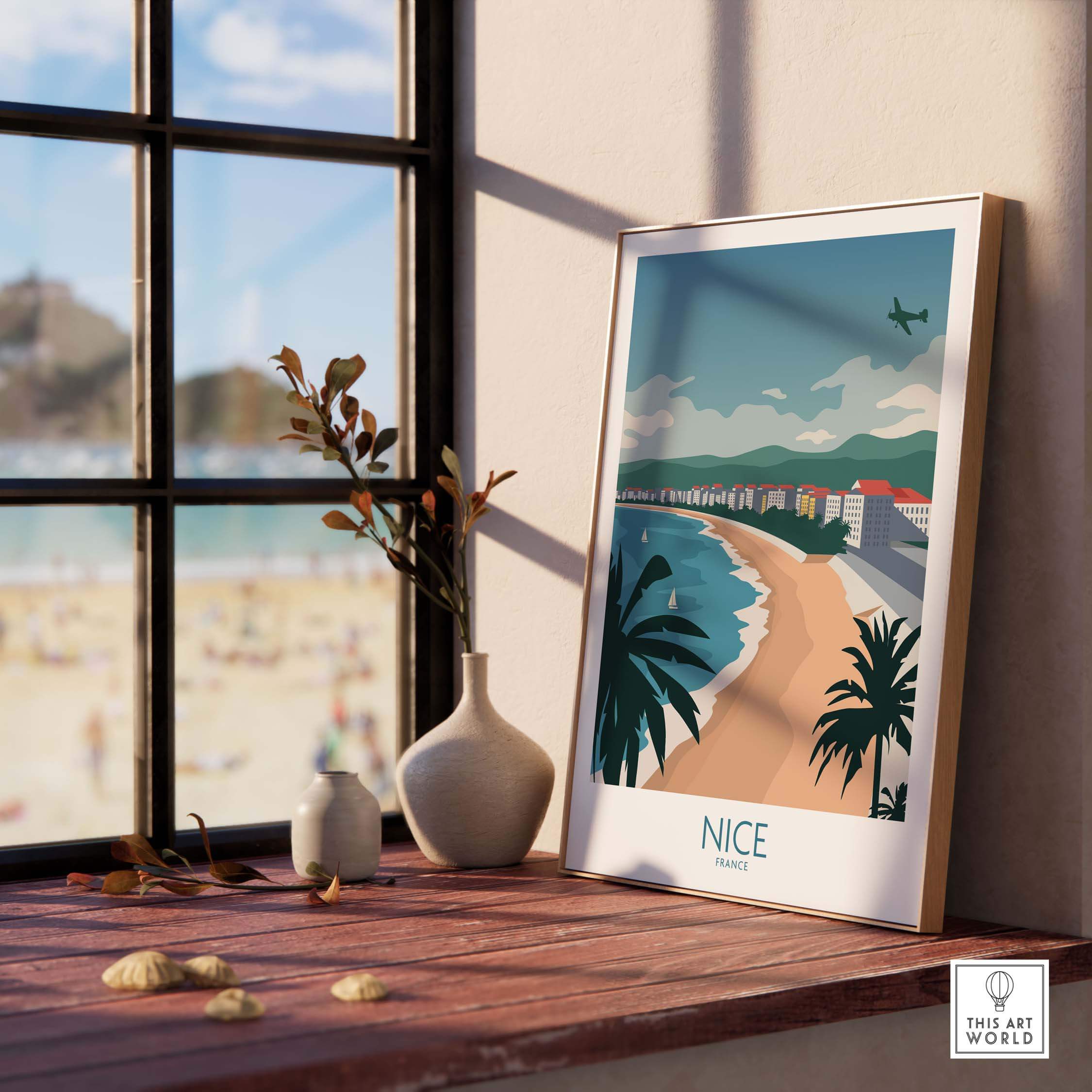 Nice France travel poster featuring a beach view with palm trees and mountains, displayed at a stylish interior.