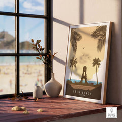 Palm Beach Florida print in a stylish frame on a wooden table, with a beach view and decorative elements.