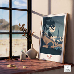 Paris France travel poster art print featuring the Eiffel Tower, framed near a window with a scenic view.