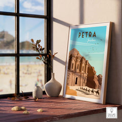 Petra Travel Poster Print showcasing the iconic Petra site in Jordan, framed on a wooden table by a window.