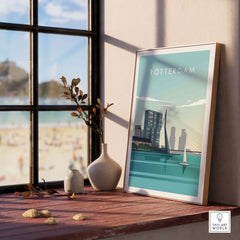 Rotterdam Print Wall Art Poster displayed in a stylish setting with a beach view, featuring vintage travel design.