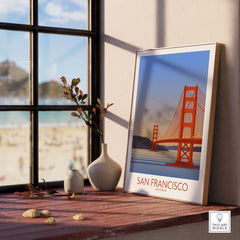 San Francisco print poster featuring the Golden Gate Bridge, framed and displayed on a table by a window.