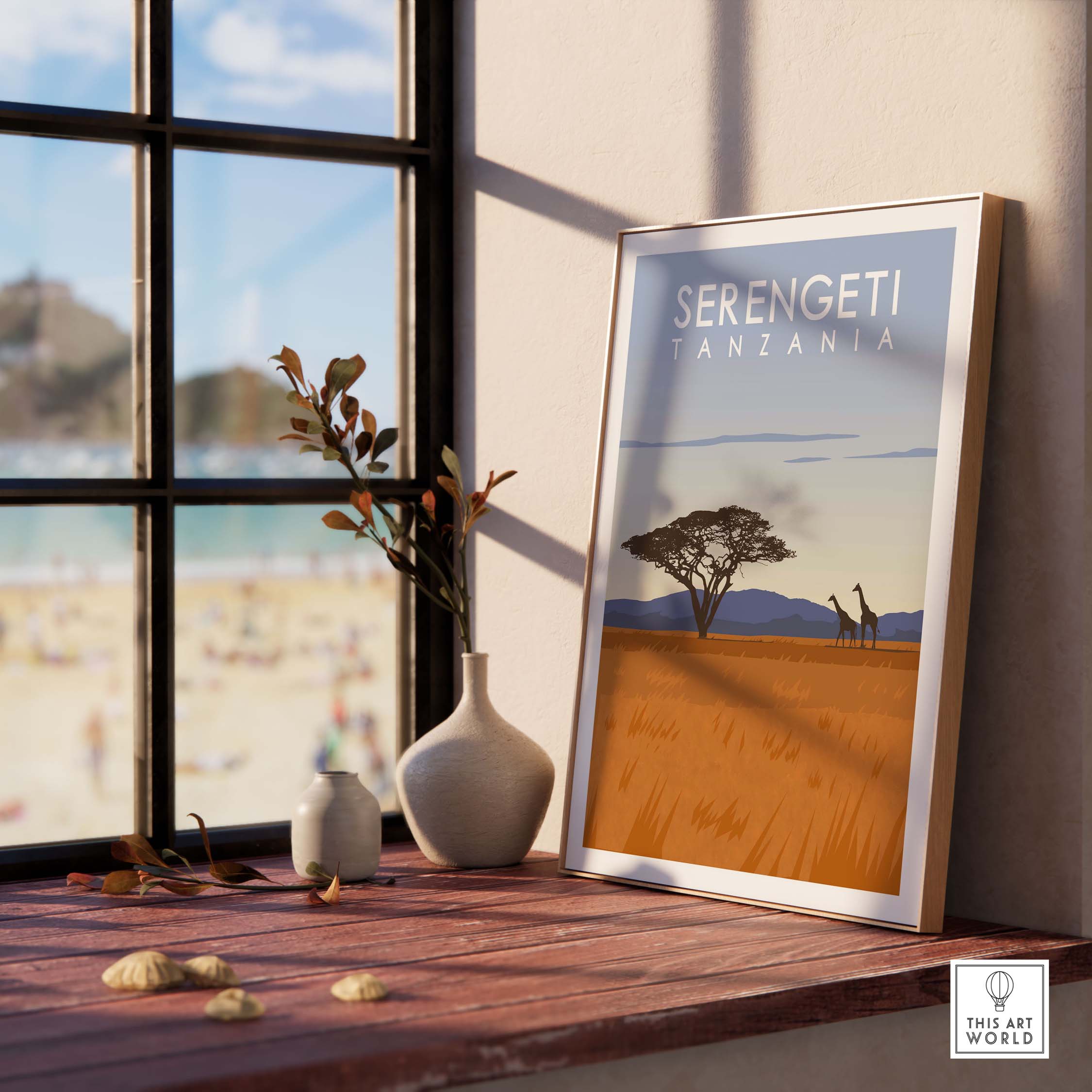Serengeti Print Tanzania travel poster featuring giraffes and acacia tree on a sunlit windowsill.