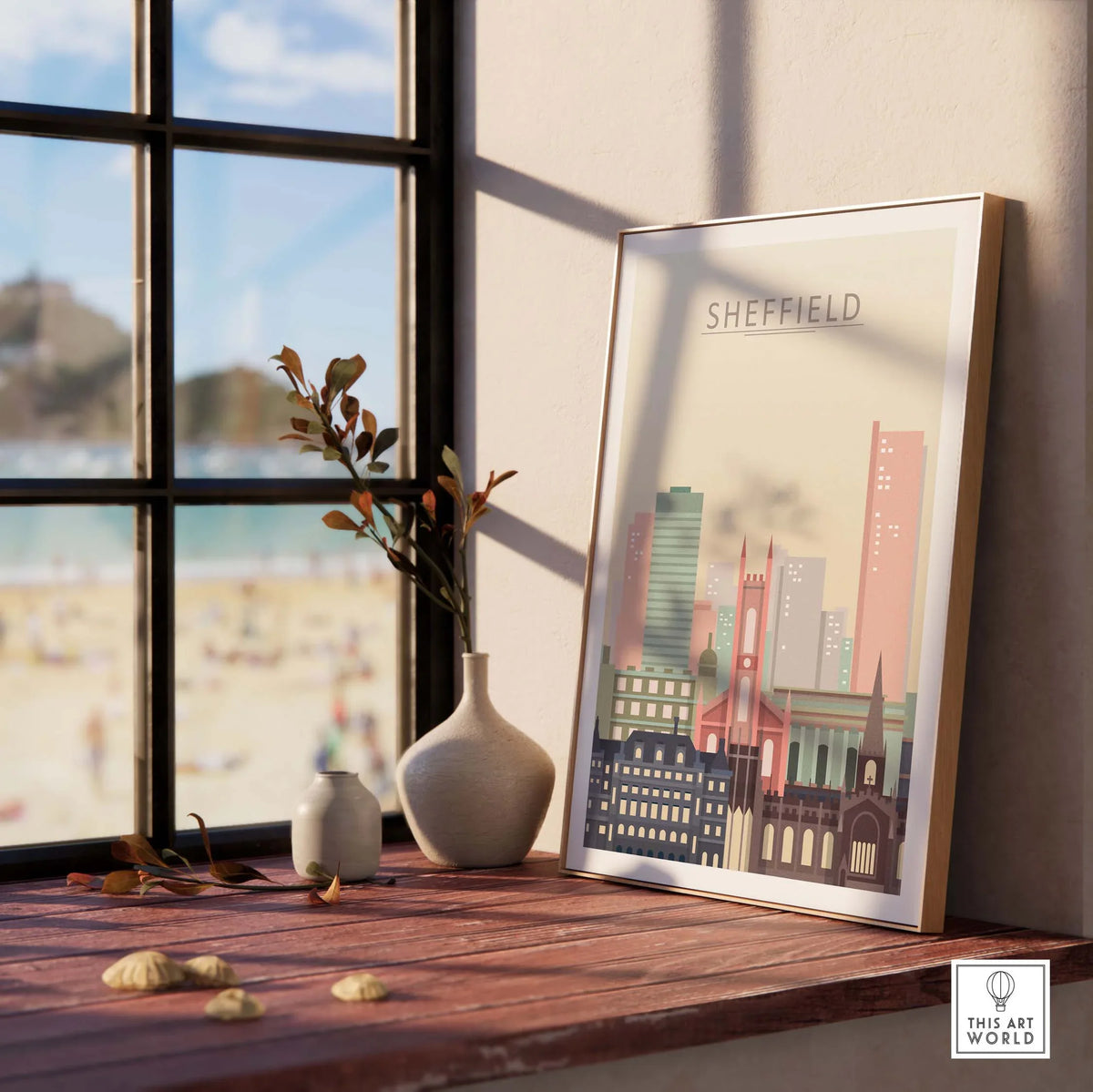 Sheffield city skyline poster displayed on a wooden table by a window, showcasing warm pastel architectural designs.
