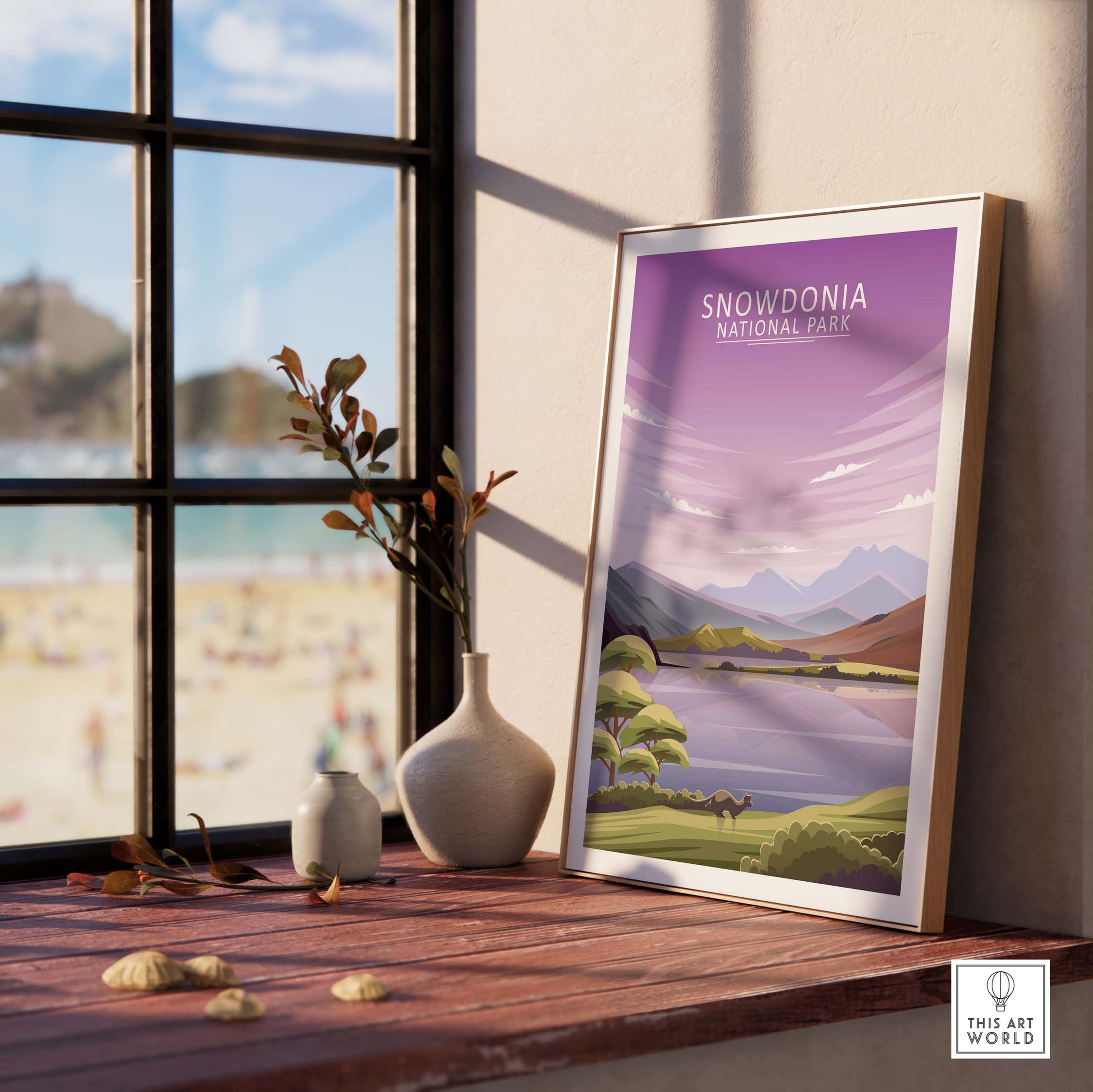 Framed Snowdonia National Park poster on a wooden table with a vase and stones, showcasing minimalist nature art.