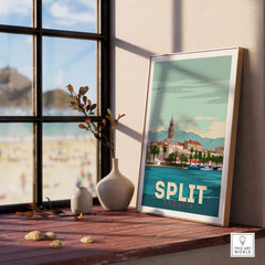 Split Croatia print poster on display by a window, showcasing coastal scenery and vintage-inspired design.