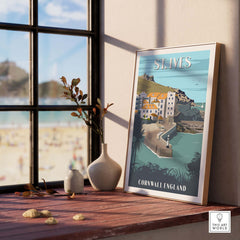 Framed St Ives poster print showcasing Cornwall, England, on a stylish side table near a window.
