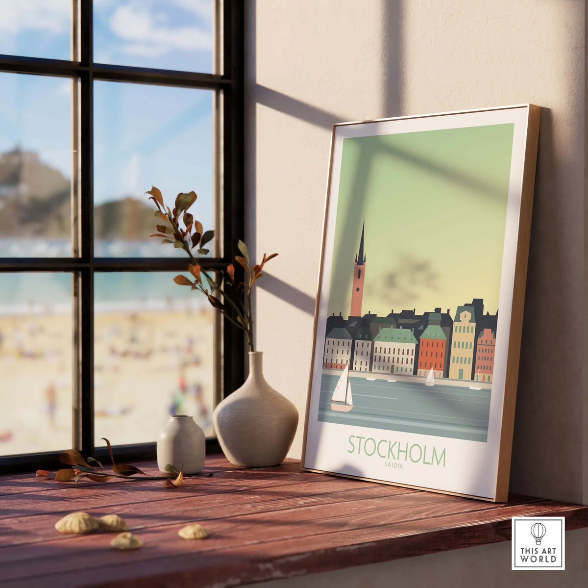 Stockholm Print Sweden Poster displayed on a wooden table by a window, featuring colorful buildings and a sailboat.