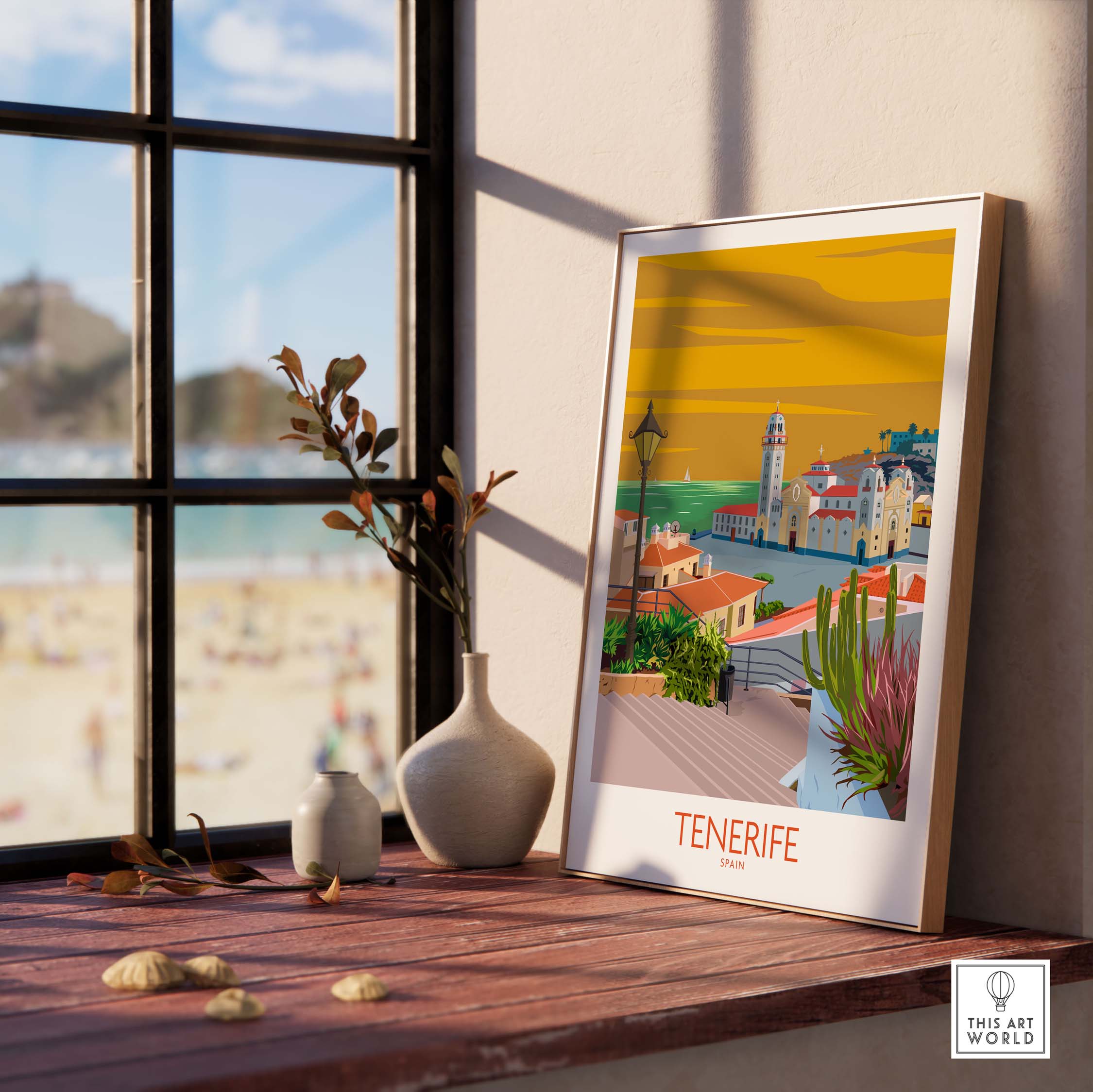 Tenerife vintage travel poster art print displayed on a windowsill with beach view in the background.