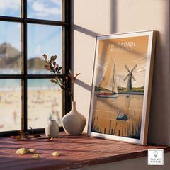 The Broads National Park poster displayed in a stylish interior, featuring a scenic landscape with a lake and windmill.