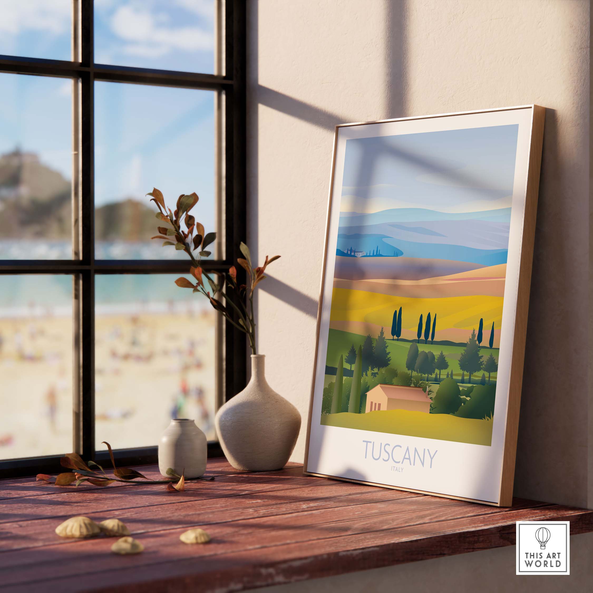 Framed Tuscany wall art print on a wooden table by a window, capturing a vibrant landscape of rolling hills in Italy.