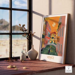 Venice Poster Travel Print on a wooden table near a window, showcasing colorful canal scene and stylish décor.