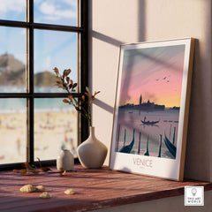 Venice print travel poster framed on a wooden table, capturing a romantic sunset view of Venice with gondolas.