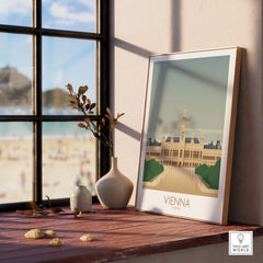 Vienna Wall Art Print displayed on a wooden table beside a window, featuring nostalgic vintage travel poster design.