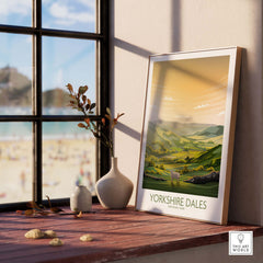 Yorkshire Dales National Park art print displayed on a wooden shelf near a window, showcasing lush green landscapes.