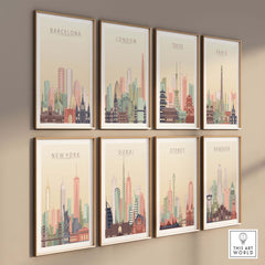 Barcelona, London, Tokyo, Paris, New York, Dubai, Sydney, Bangkok skyline prints in pastel tones on a wall.