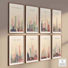 Framed city skyline prints on wall featuring San Francisco, London, Tokyo, Paris, New York, Dubai, Sydney, and Bangkok.